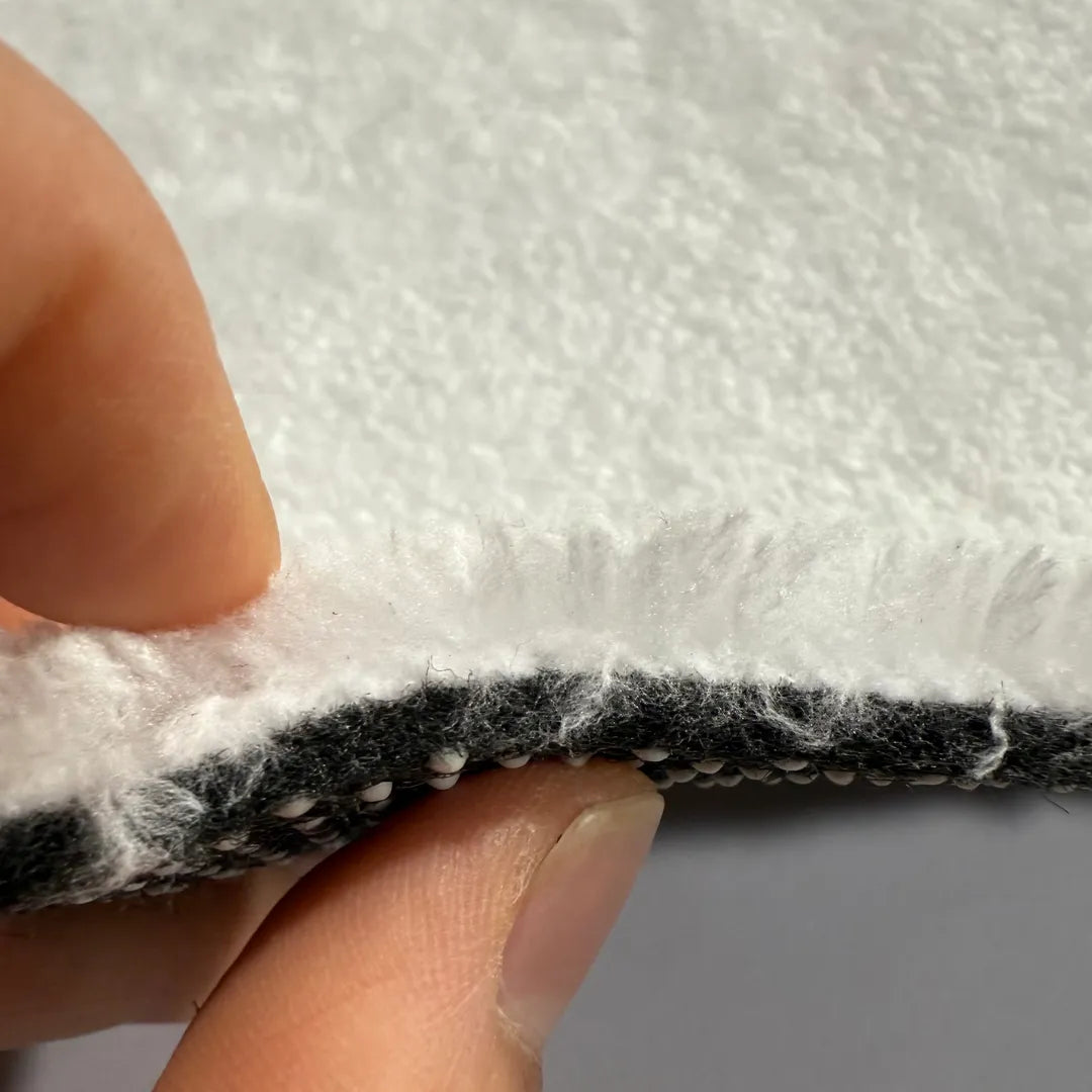 Cross-section detail of faux cashmere rug showing pile, middle layer and non-slip backing.