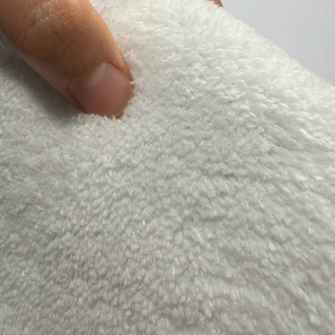 Close-up of soft faux cashmere rug pile showing plush, wool-feel texture.