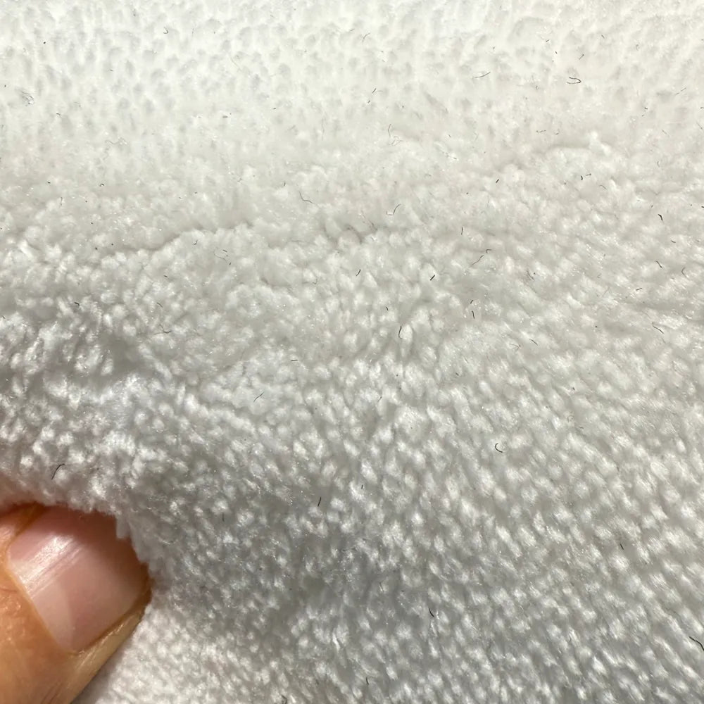 Close-up of soft faux cashmere rug pile showing plush, wool-feel texture.