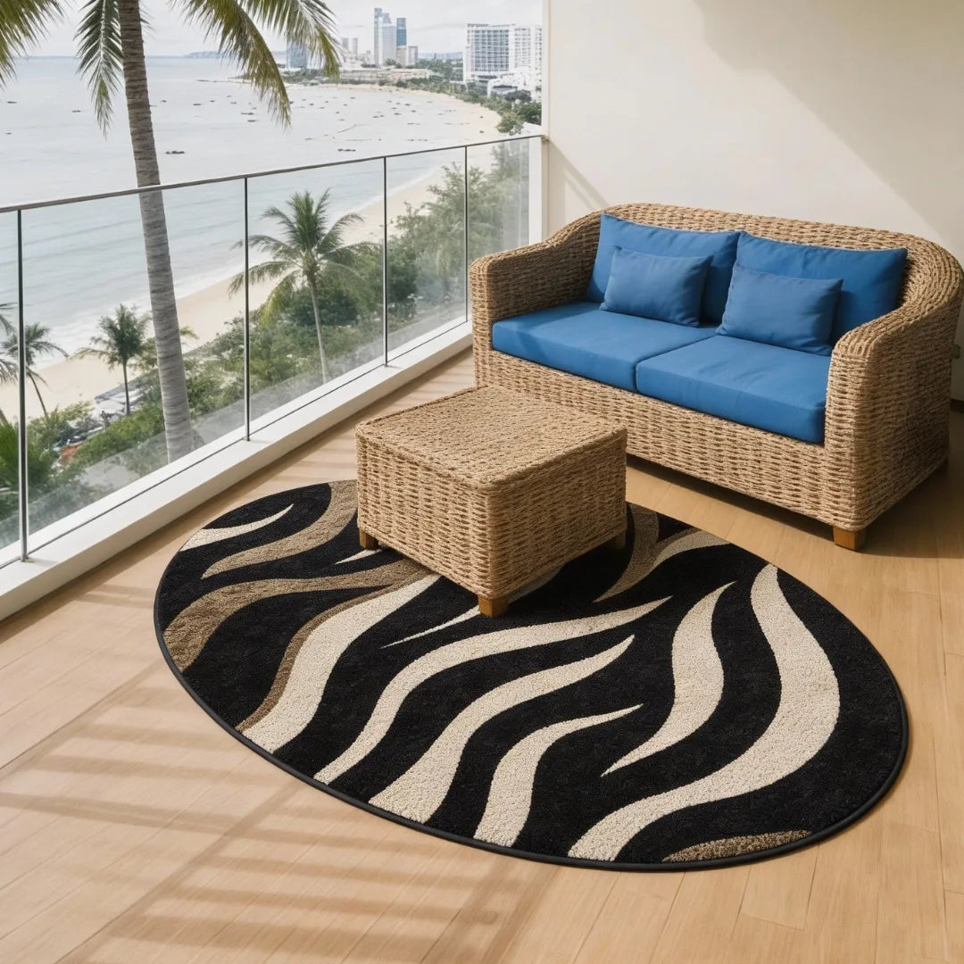 Black and white zebra wave rug placed on a modern balcony with ocean view and rattan furniture