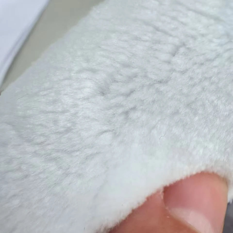 Detailed close-up of the soft white faux silk rug surface and fine fibers