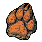 Bear claw shaped rug featuring bold paw print design in earthy orange, charcoal, and stone textures
