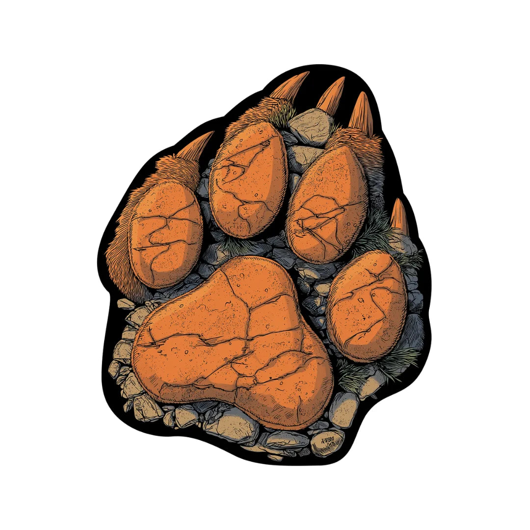 Bear claw shaped rug featuring bold paw print design in earthy orange, charcoal, and stone textures