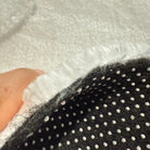 Cross-section detail of faux cashmere rug showing pile, middle layer and non-slip backing.