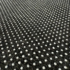 Close-up of the non-slip dotted backing on the 5ft round abstract wave faux cashmere rug from A Print Nest