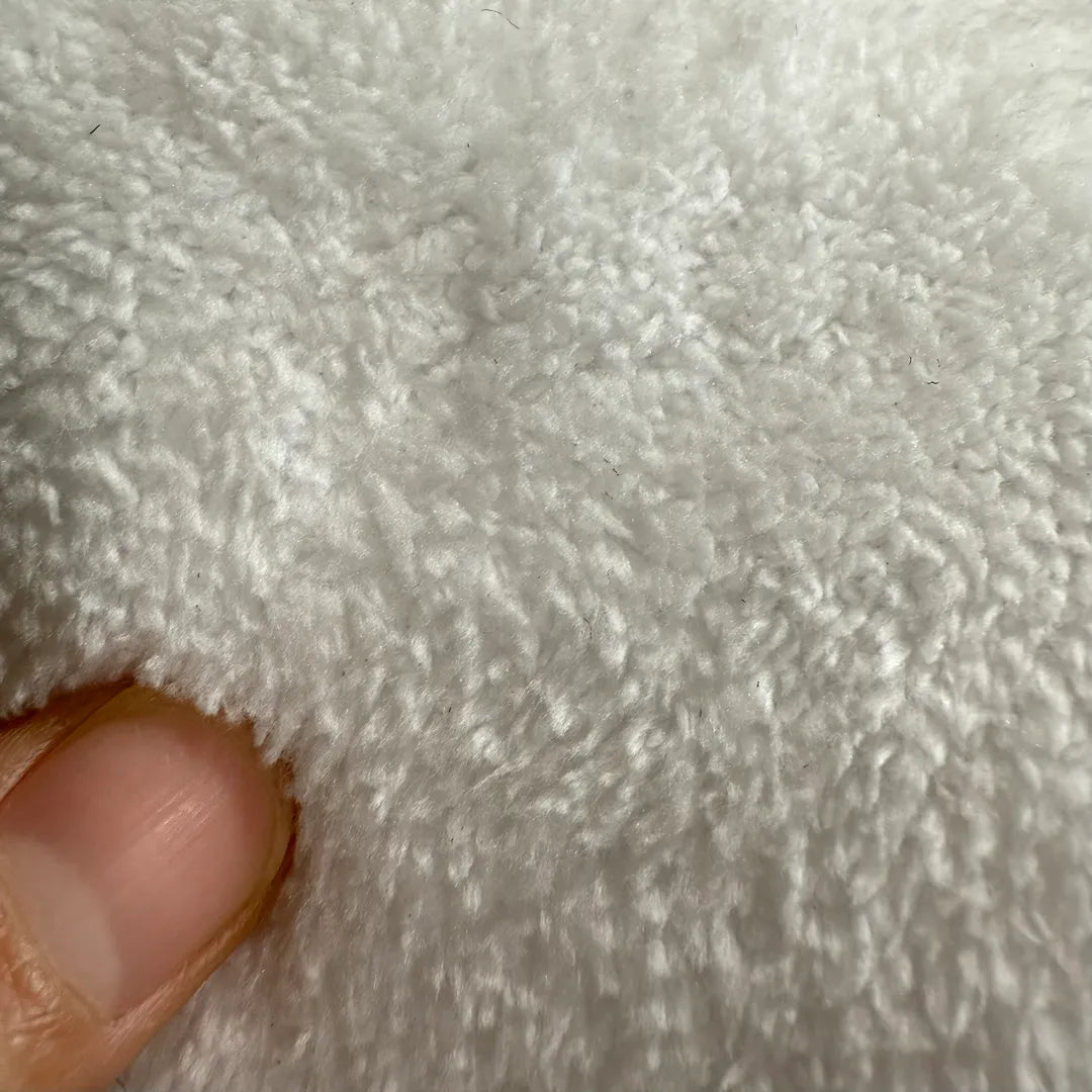 Close-up of soft faux cashmere rug pile showing plush, wool-feel texture.