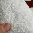 Close-up of soft faux cashmere rug pile showing plush, wool-feel texture.