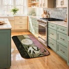 Abstract geometric rug placed in a bright modern kitchen with sage cabinets, wooden floors, and natural daylight