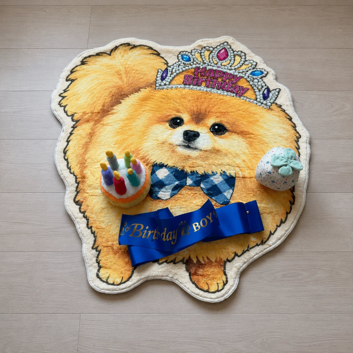Custom Pomeranian birthday rug flatlay with birthday toys and blue birthday sash
