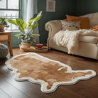 Abstract earth-toned irregular rug placed in a cozy living room with plants, soft seating, and natural light