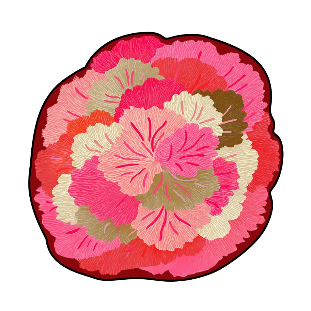 Irregular pink floral rug featuring layered rose-pink petals in blush, coral, and cream tones