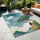Irregular-shaped faux cashmere rug placed in a serene balcony space, featuring a solitary figure under a tree against an open sky.
